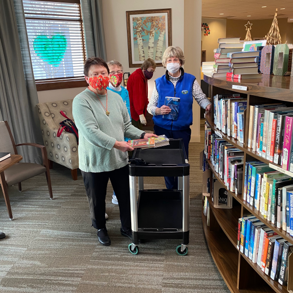 Oak Village Prairie Ridge resident volunteers stock their book nook
